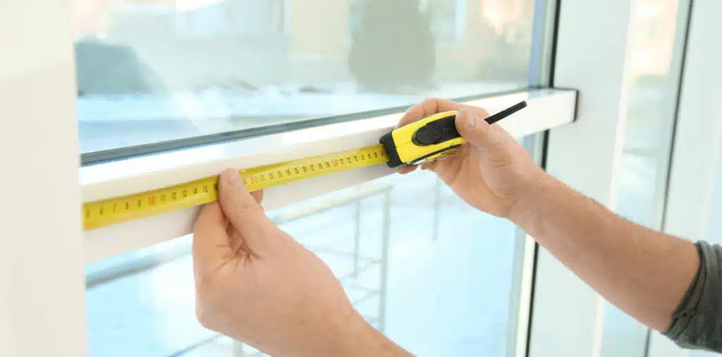 Service man measuring window for installation indoors, closeup
