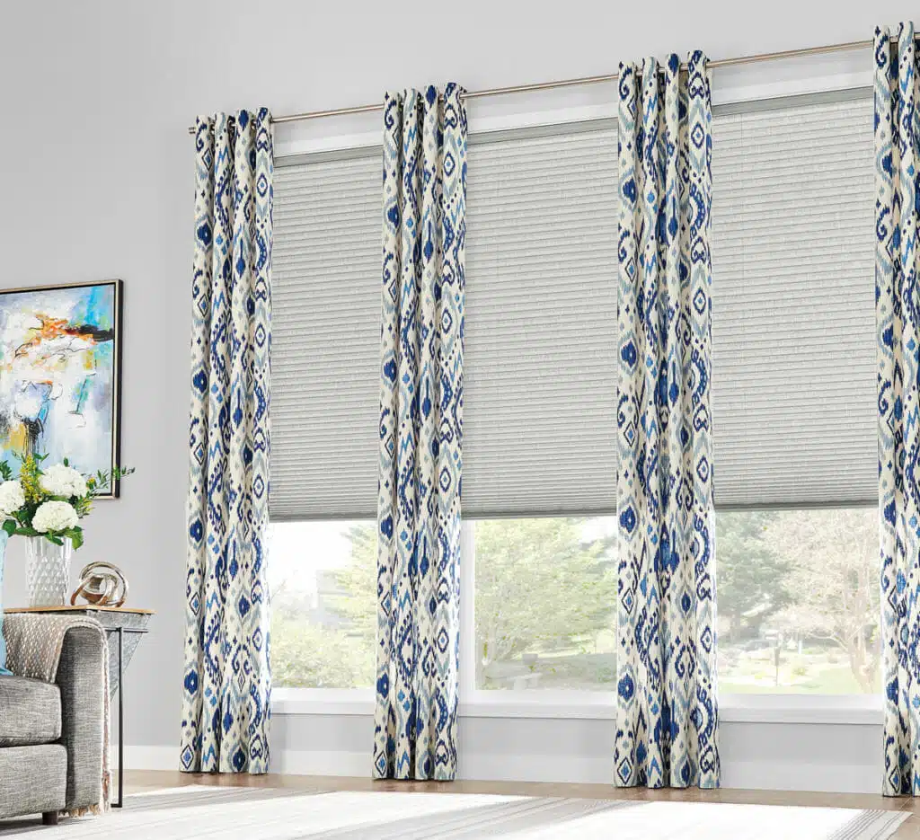 how-to-layer-11 Contrast between solid-color cellular shades and patterned curtains