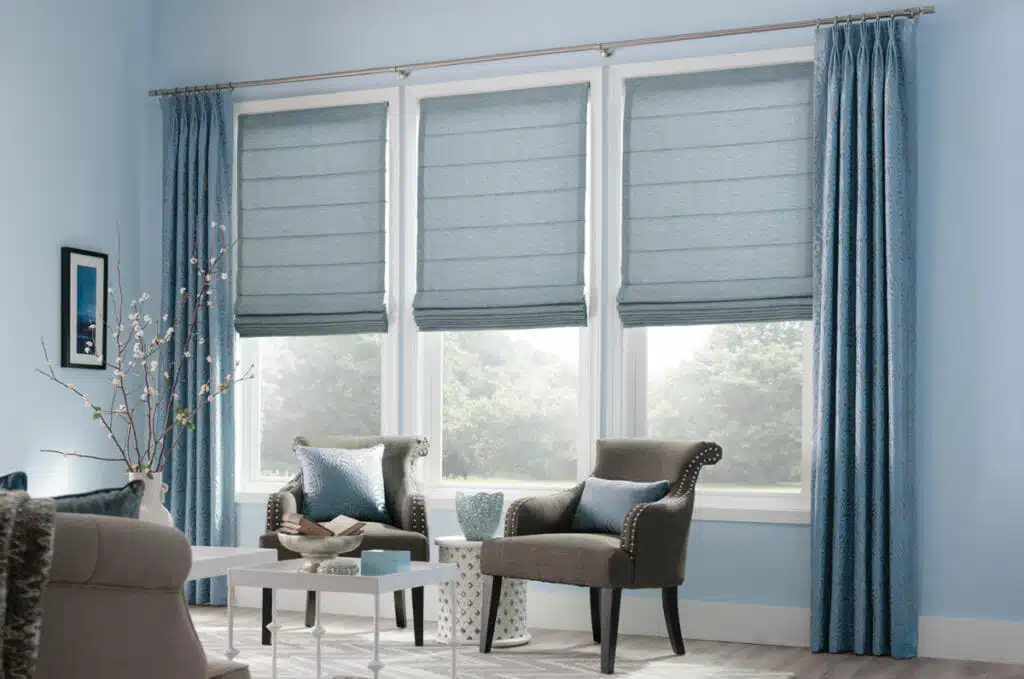 how-to-layer-2 Classic flat Roman shades paired with patterned curtains