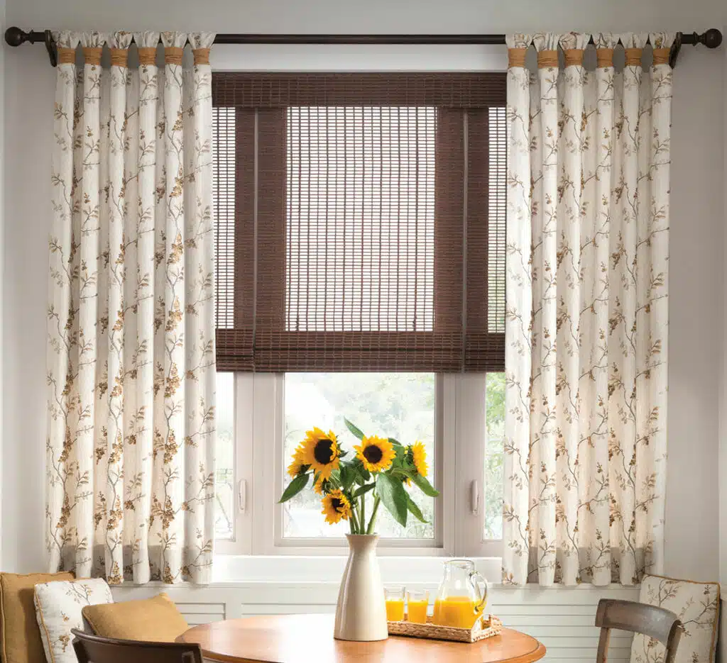 how-to-layer-4 Fabric drapes create contrast with woven wood shades