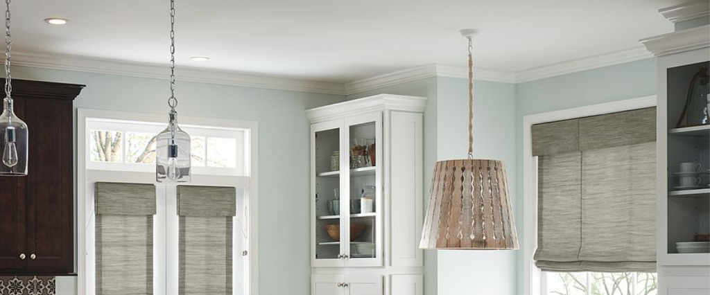 Monochromatic kitchens are trendy and adding a valance and Roman shade in the same fabric will create a tailored look.