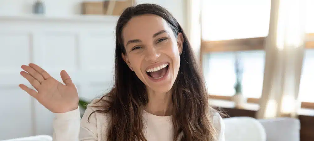 Portrait of smiling young girl greeting talking on web