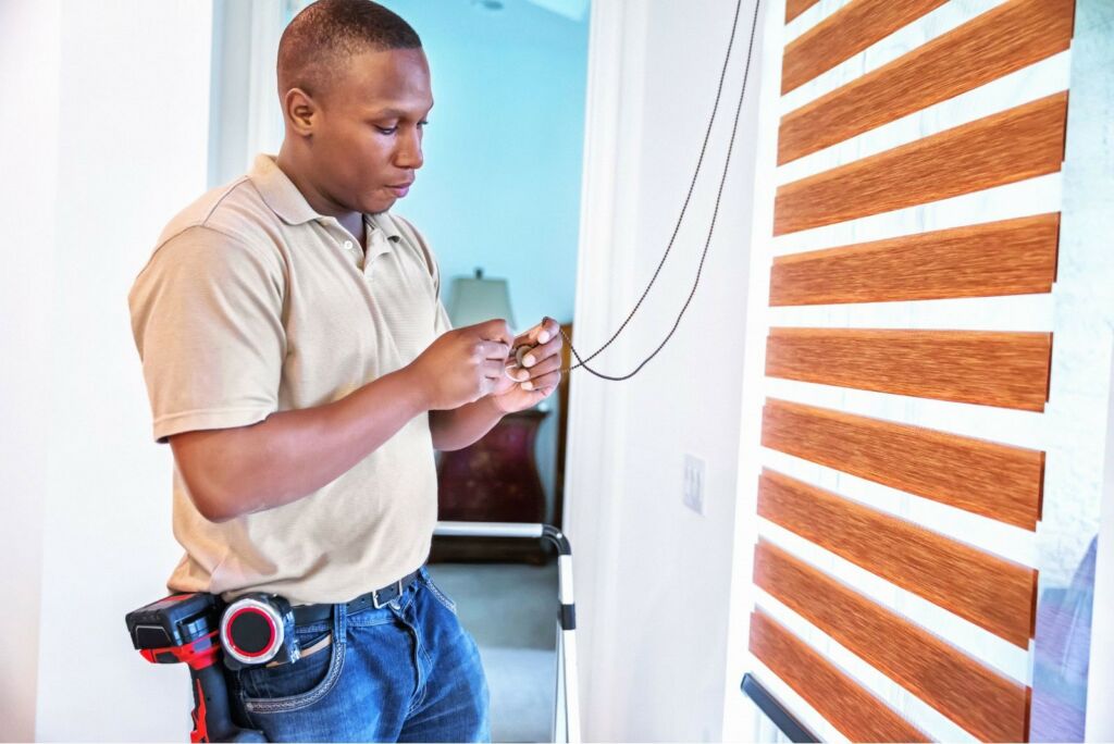 picture of man installing home with safe window treatments