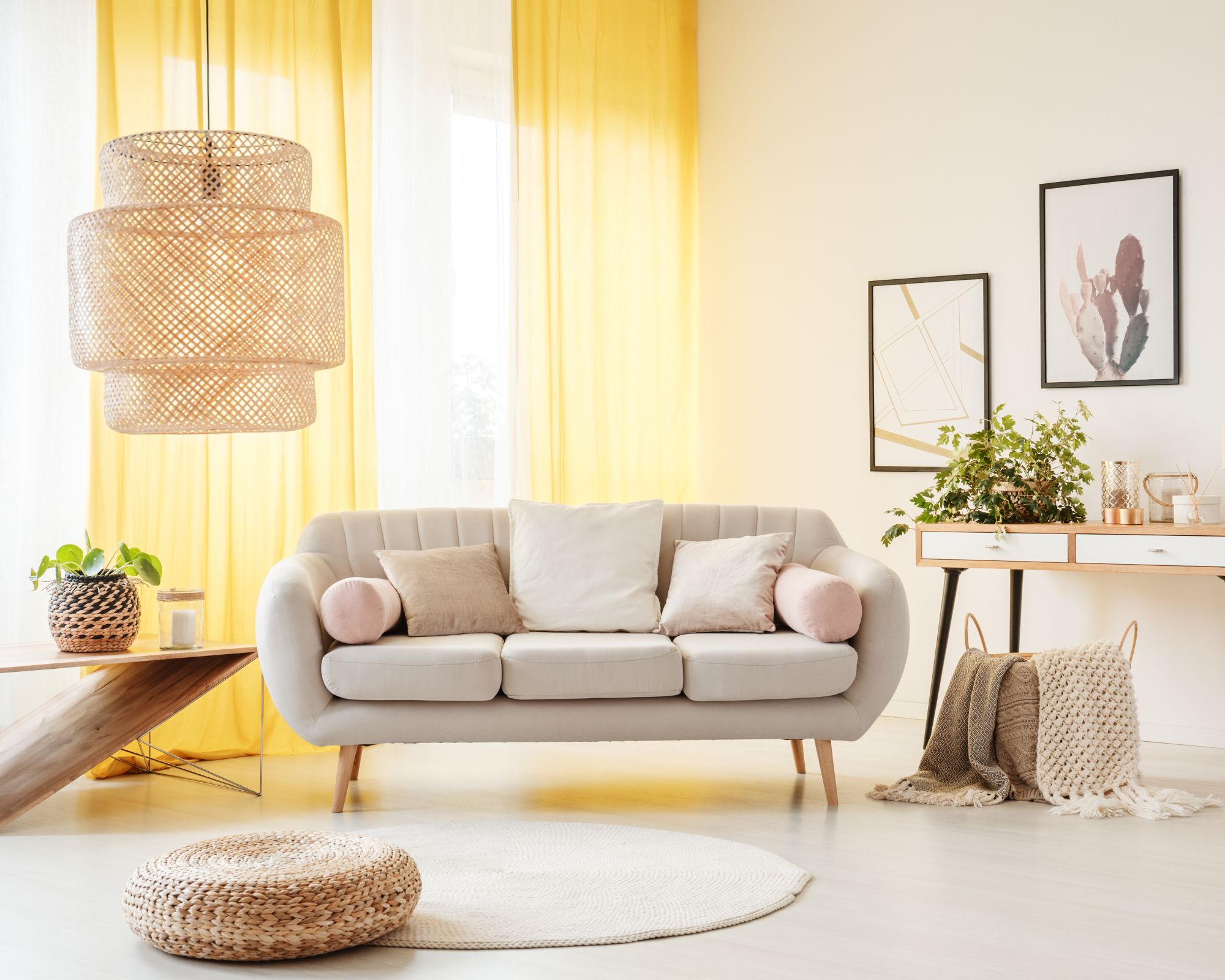 image of living space with a woven rug, rattan lamp, and nature-inspired décor
